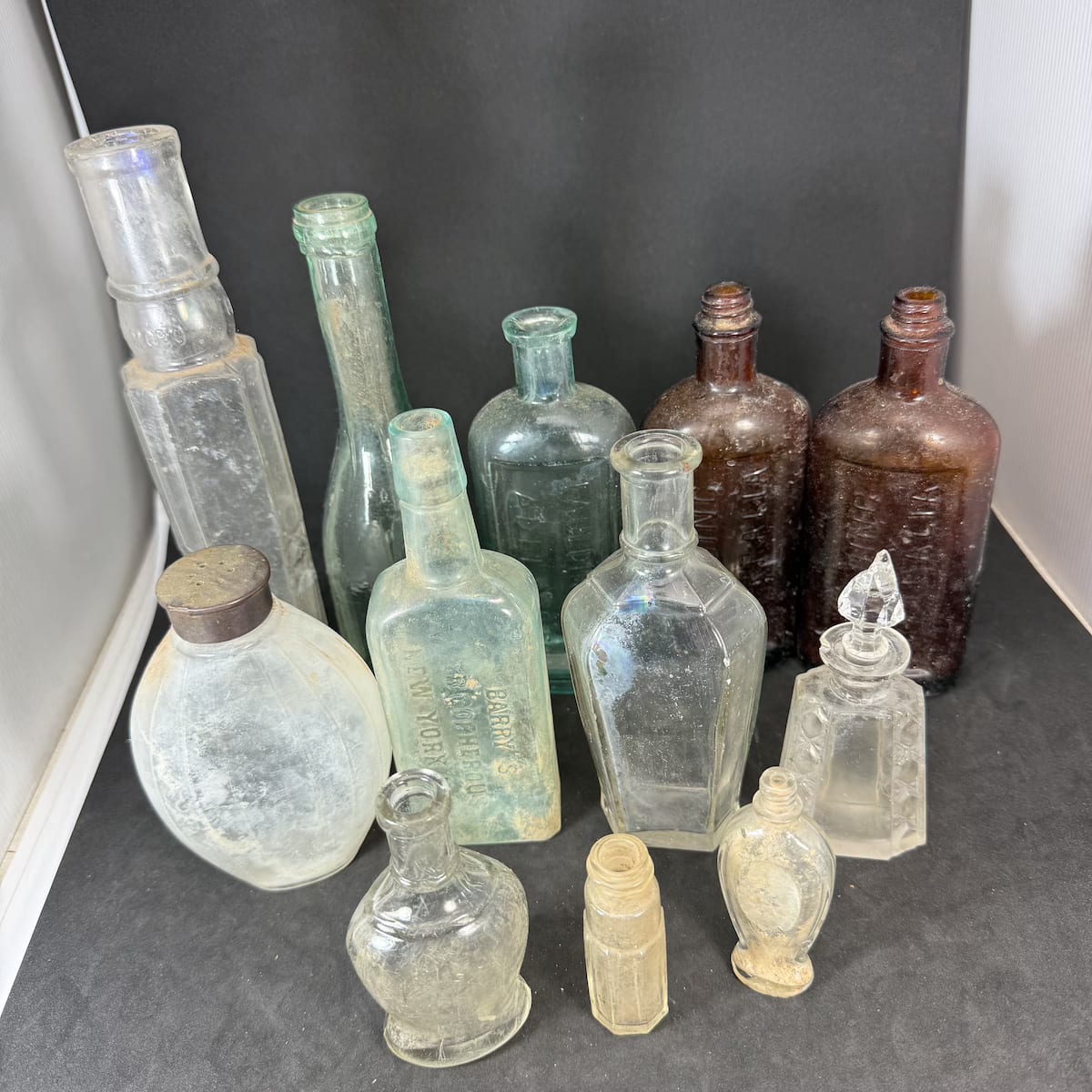 12 Small Bottles: Perfumes; Cosmetics; Medicines etc. Faulding. Genova.