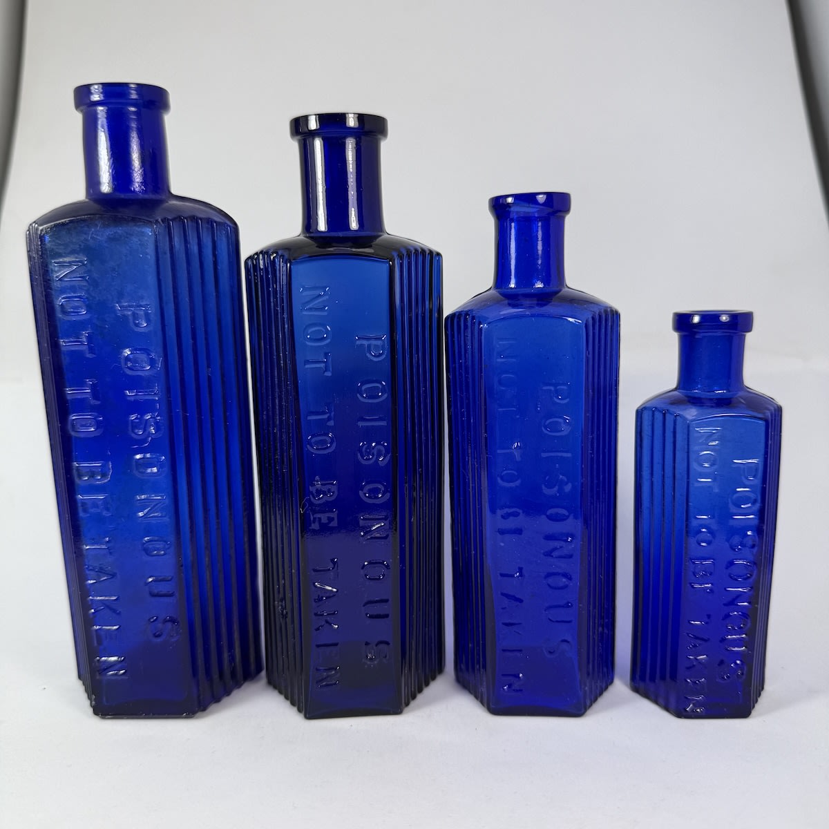 4 Hexagonal Cobalt Blue Poisons. All Poisonous / Not to be Taken. 8, 6, 4 & 2 oz. 167, 156, 137 & 105 mm.