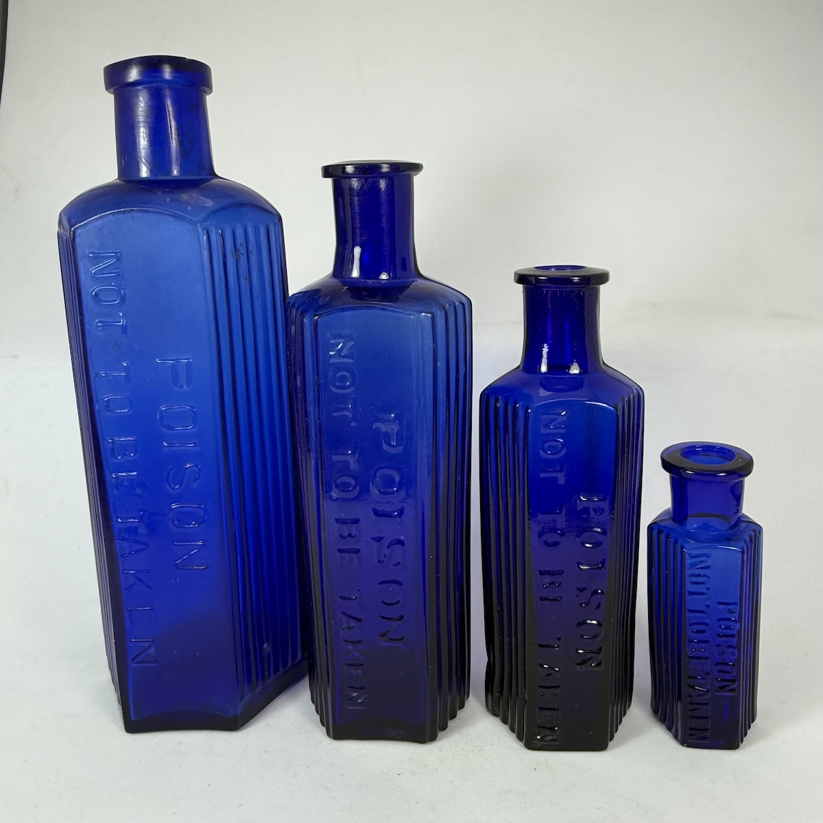 4 Hexagonal Cobalt Blue Poisons. All Poison / Not to be Taken. 8, 4, 2 & 1/2 oz. 164, 139, 113 & 70 mm.