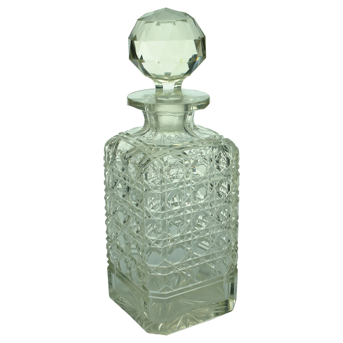 Glassware. Square hobnail cut decanter with star pattern on base.