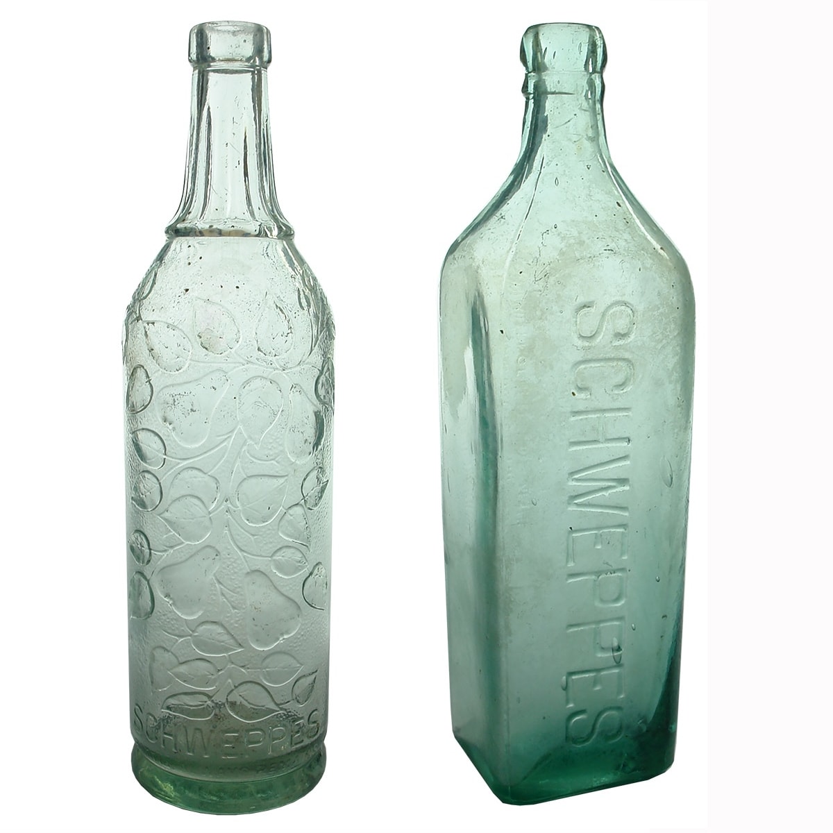 2 Schweppes Cordials: Round fancy one with fruit and leaves pattern; Square one with just Schweppes down the front but very long "Property of" warning in four lines on the back.