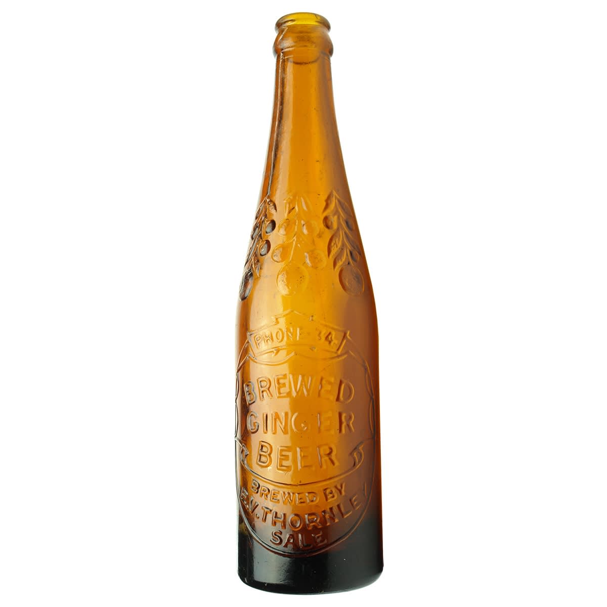 Crown Seal Glass Ginger Beer. E. V. Thornley, Sale. Phone 34. Fruit & Branches around shoulder. Amber. 10 oz. (Gippsland, Victoria)