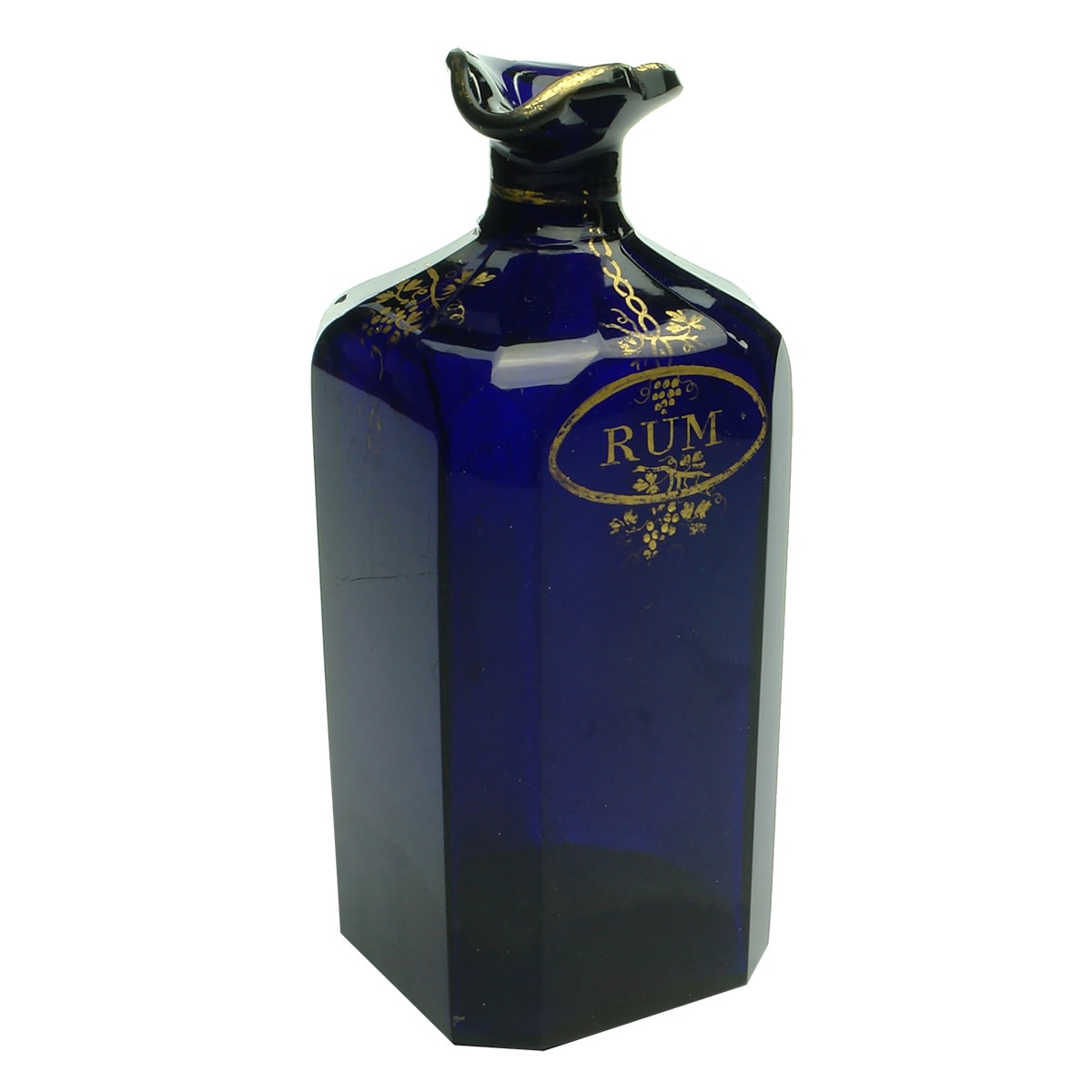 Rum bottle from a coaching set. Cut dark cobalt blue glass. Gold leaf decoration. Polished pontil scar to base.