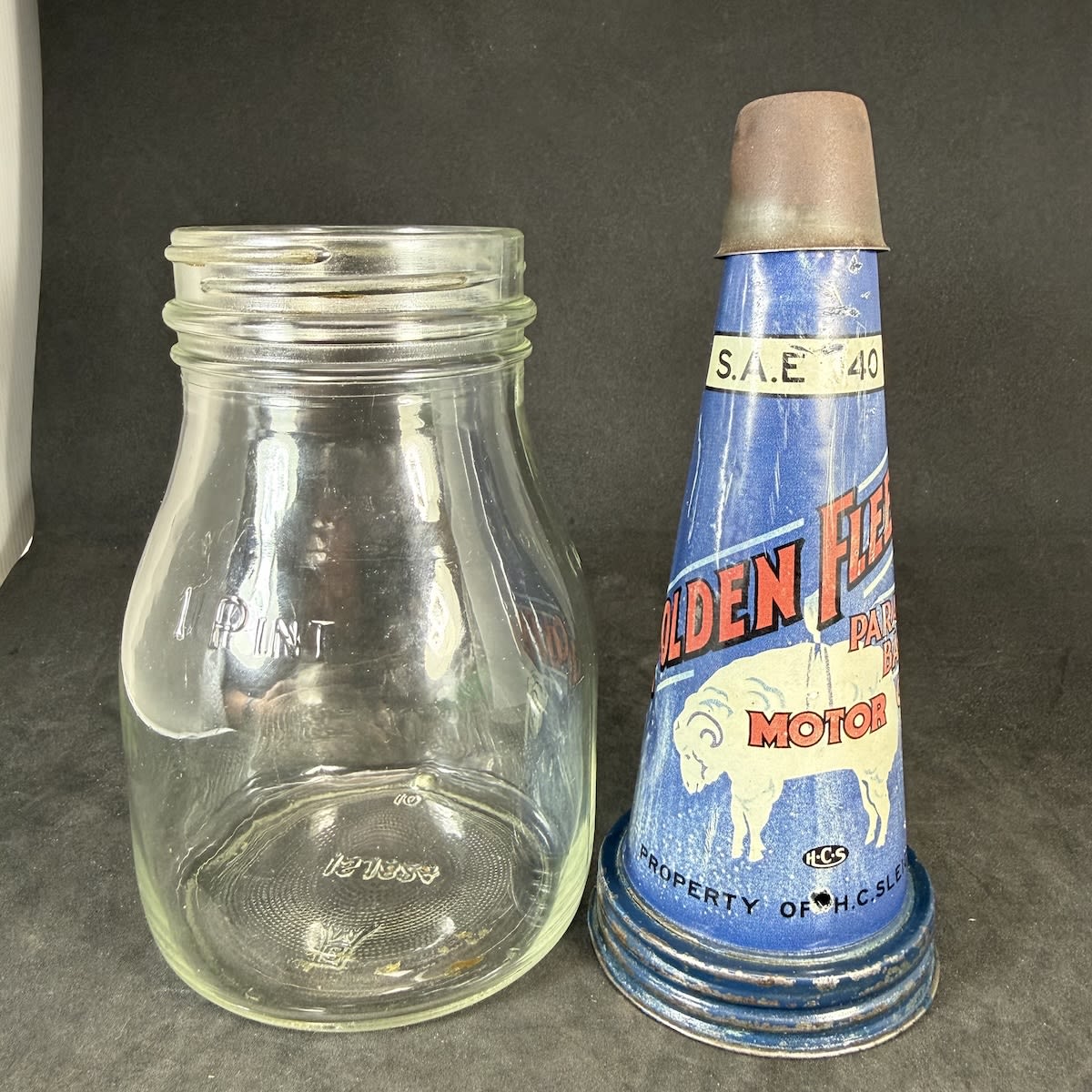 Reproduction Tin Oil top. Hanging Ram Golden Fleece Paraffin Base Motor Oil. SAE 40. H. C. Sleigh. Original Generic 1 Pint bottle.