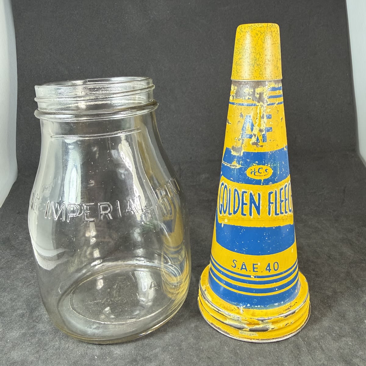 Oil Bottle & Tin Pourer. Golden Fleece HCS H. C. Sleigh Limited. Newcastle & Adelaide still visible in print. SAE 40. AF. Generic Imperial Pint bottle.