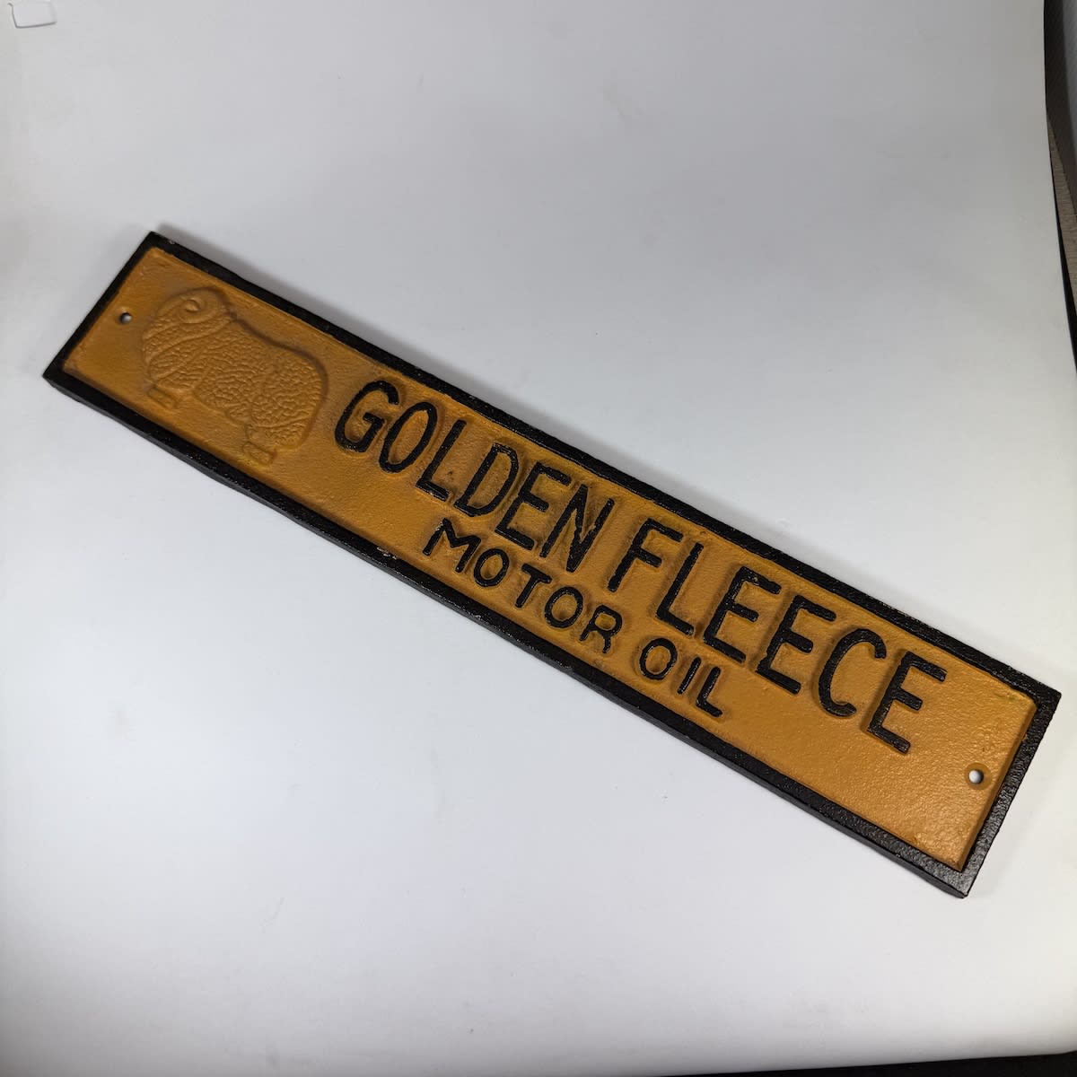 Embossed Fantasy Cast Iron Sign. Golden Fleece Motor Oil. Ram. Sleigh 1952 on back.