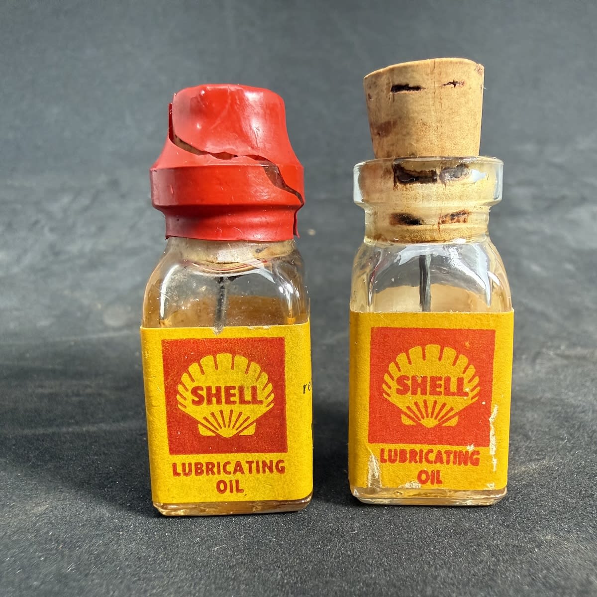2 Items. Garagenalia. Shell Lubricating Oil bottle for Tri-ang Trains. One with partical contents. Both with corks and applicator.