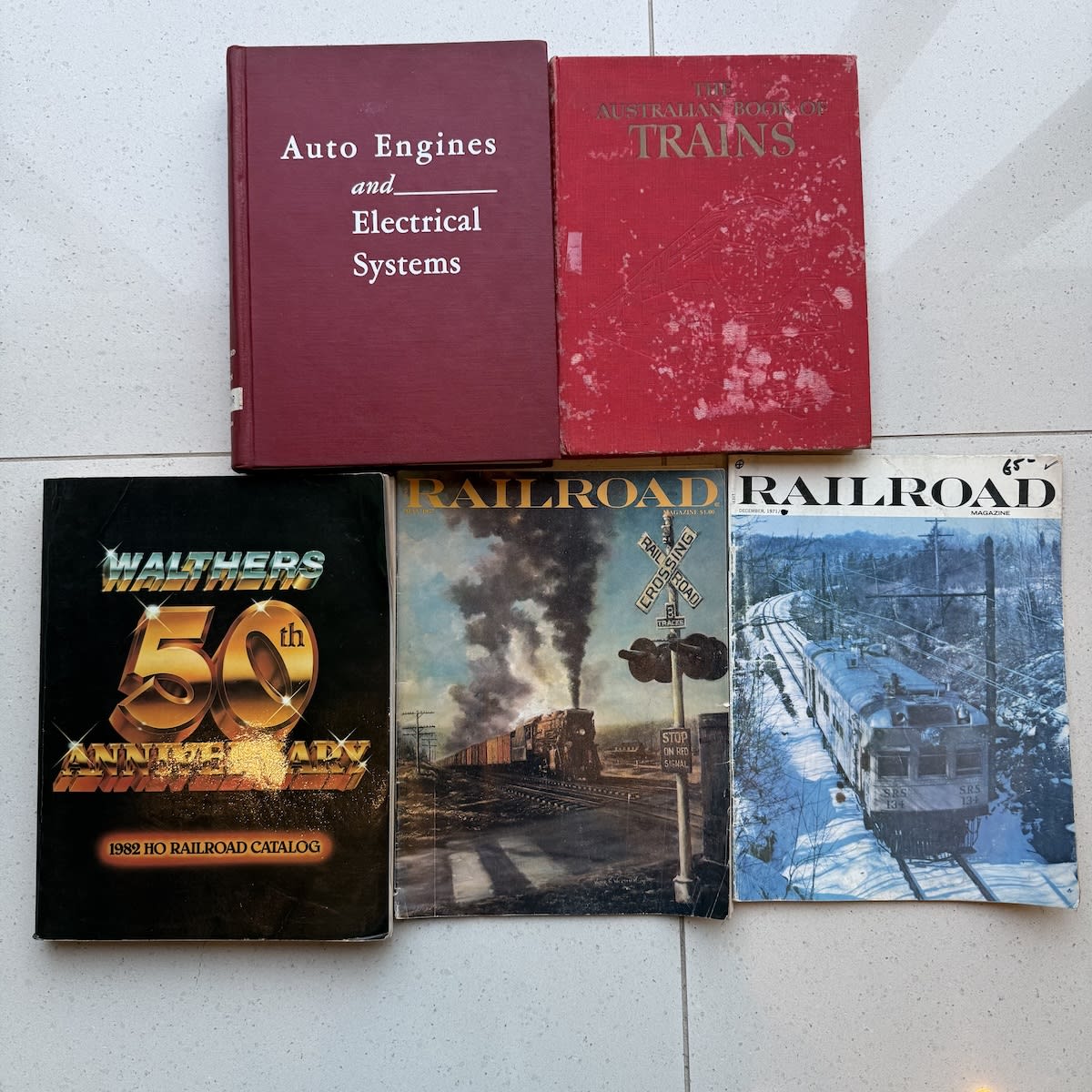 5 Books & Magazines: Auto Engines & Electrical Systems 1960; The Australian Book of Trains 1947; 2 1970s Railroad Magazines; Walthers 1982 HO Railroad Catalog.