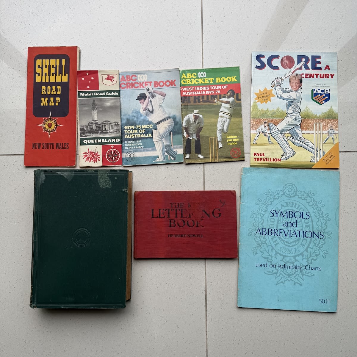 Random group of 8 Books, Magazines and Maps: The Australian Encyclopaedia Vol II MAB to Z 1926; NSW & QLD Road Maps; The Key Lettering Book; Symbols on Admiralty Charts; 3 x Cricket books.