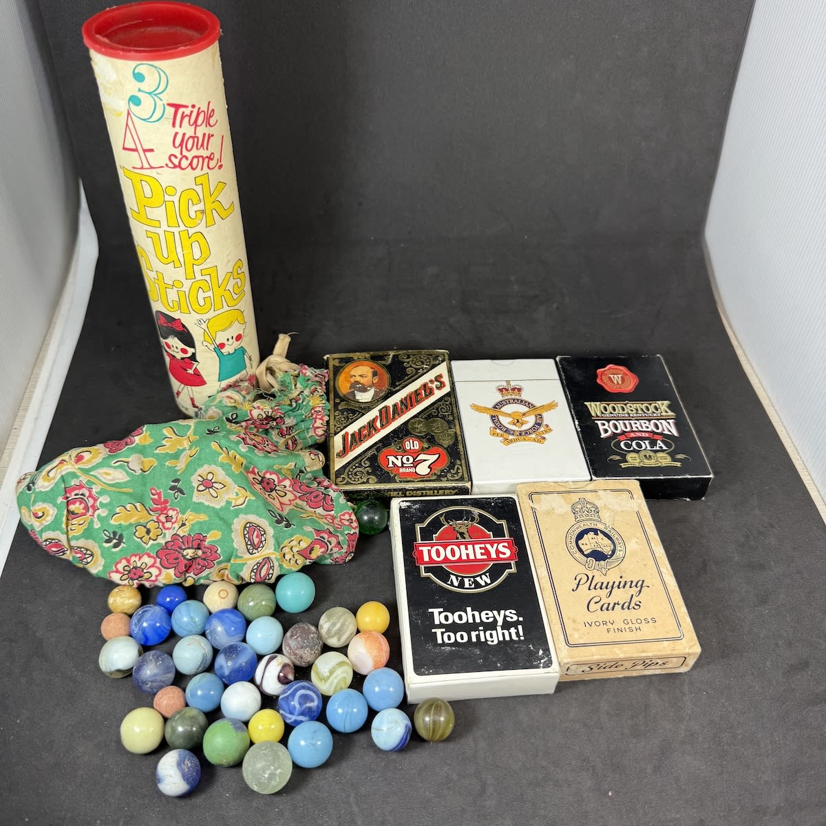 Games! Bag of Marbles in cloth bag; Pick up sticks in tall container; 5 packs of advertising or promotional playing cards.