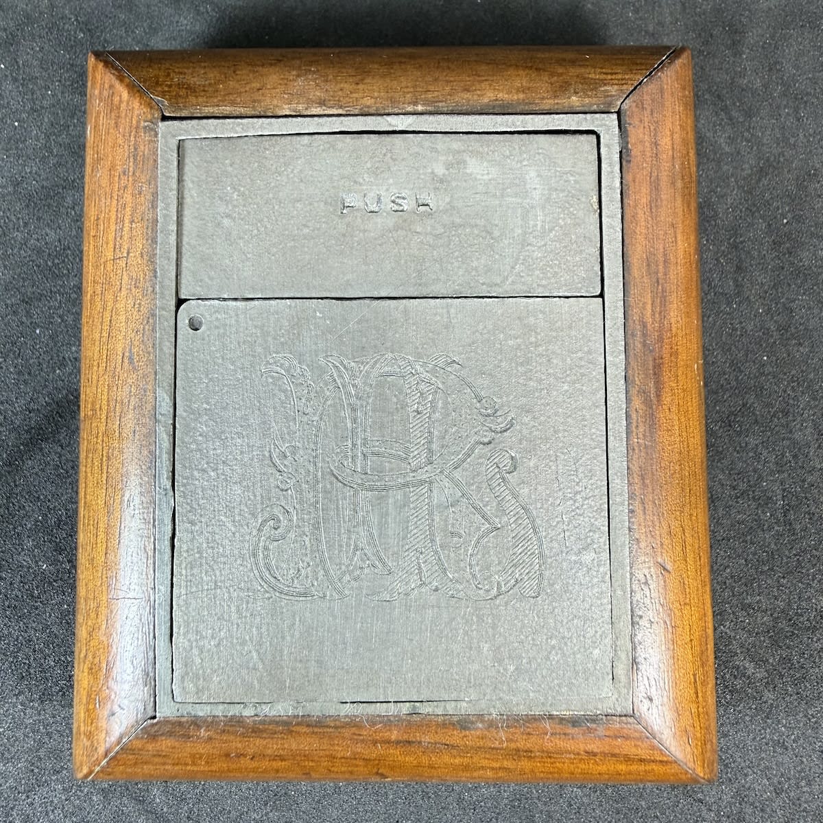 Travel Inkwell. Ransome's Patent. De La Rue & Co. Heavy pewter lidded container inside a wooden frame. Fancy monogram to one side. Ground lip glass inkwell inside the metal container.