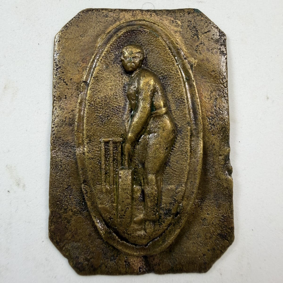 Cricket Belt Buckle / Sash Buckle. Heavy brass piece with an oval pinned piece featuring a batsman standing upright in front of stumps.