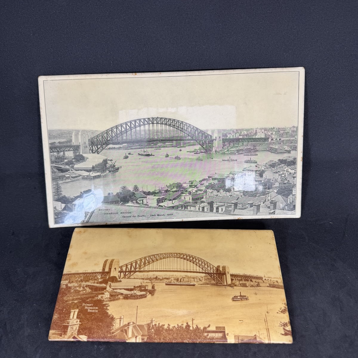 2 Celluloid covered souvenir photographs of Sydney Harbour Bridge. 1930s.