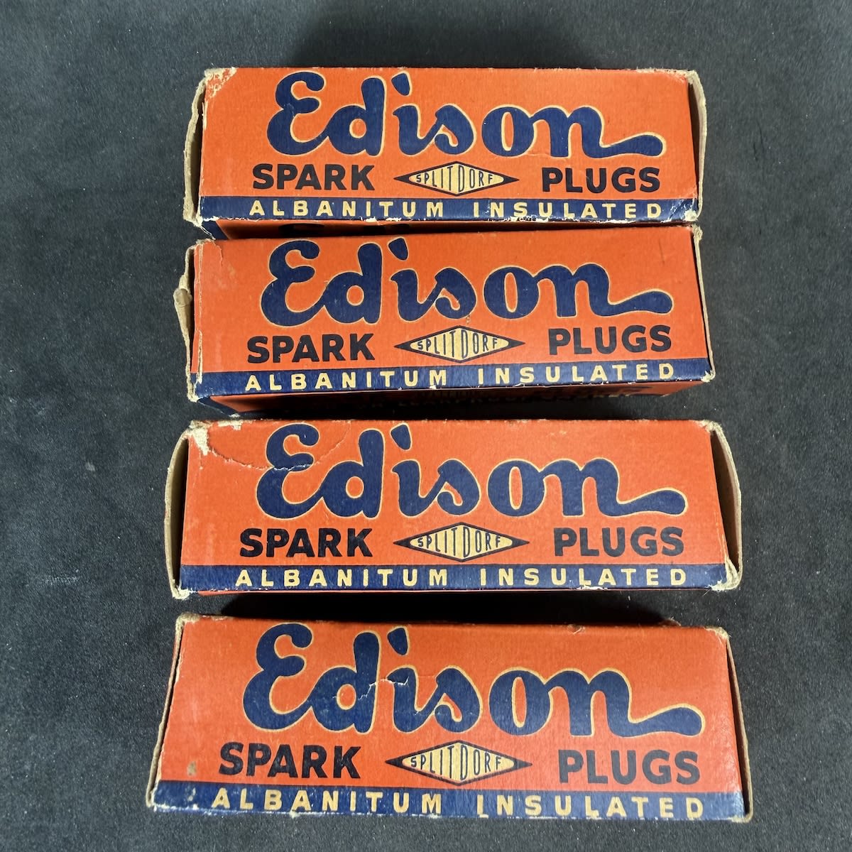 4 Spark Plugs. Original Edison Albanitum Insulated. Manufactured by Edison-Splitdorf Spark Plug Manufacturers Pty Ltd Sydney Australia under special arrangement with Thomas A. Edison Inc. West Orange, New Jersey USA. Spark plugs in original wax paper inside.
