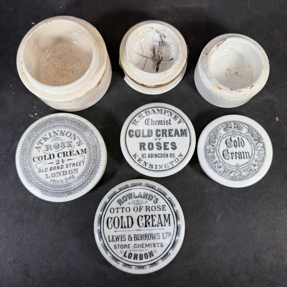4 Cold Cream Pot Lids: Atkinson's London; Rowland's Otto of Rose, Lewis & Burrows Ltd; R. S. Dampney, Kensington; Generic Gothic pattern.