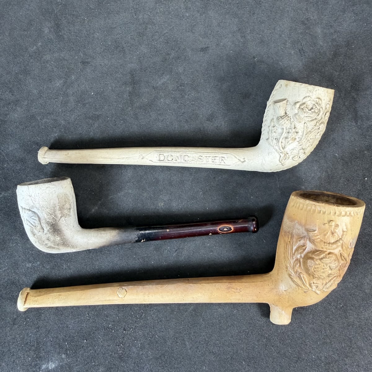 3 Complete Clay Pipes: Globe & Horn; Rose, Shamrock & Thistle, G. Ward Doncaster; Crossed Flags, Union Jack & Irish Flags.