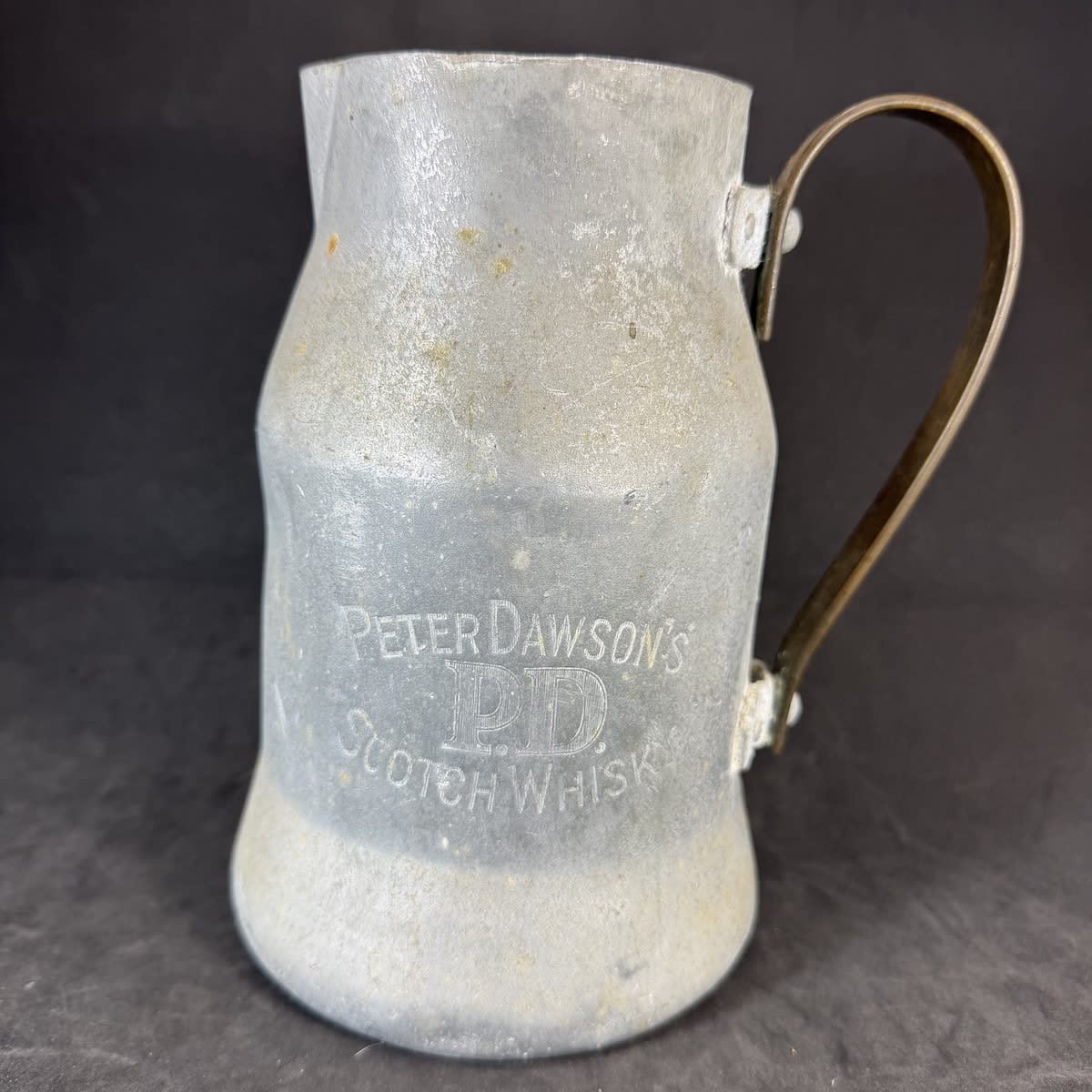 Whisky Water Jug. White Metal with brass handle. Peter Dawson's PD Scotch Whisky.