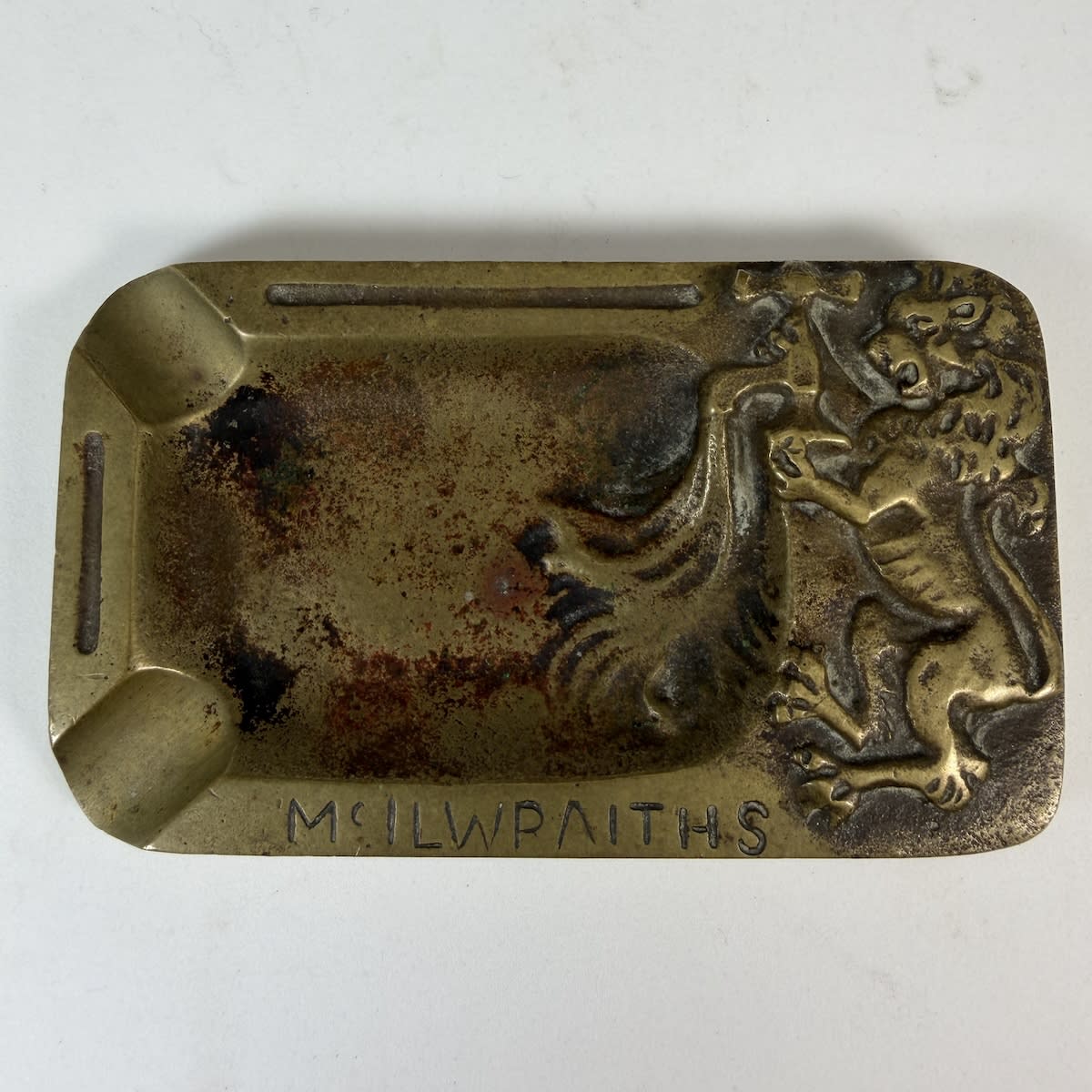 Small heavy brass ashtray. McIlwraiths. Rampant Lion turning on a tap.