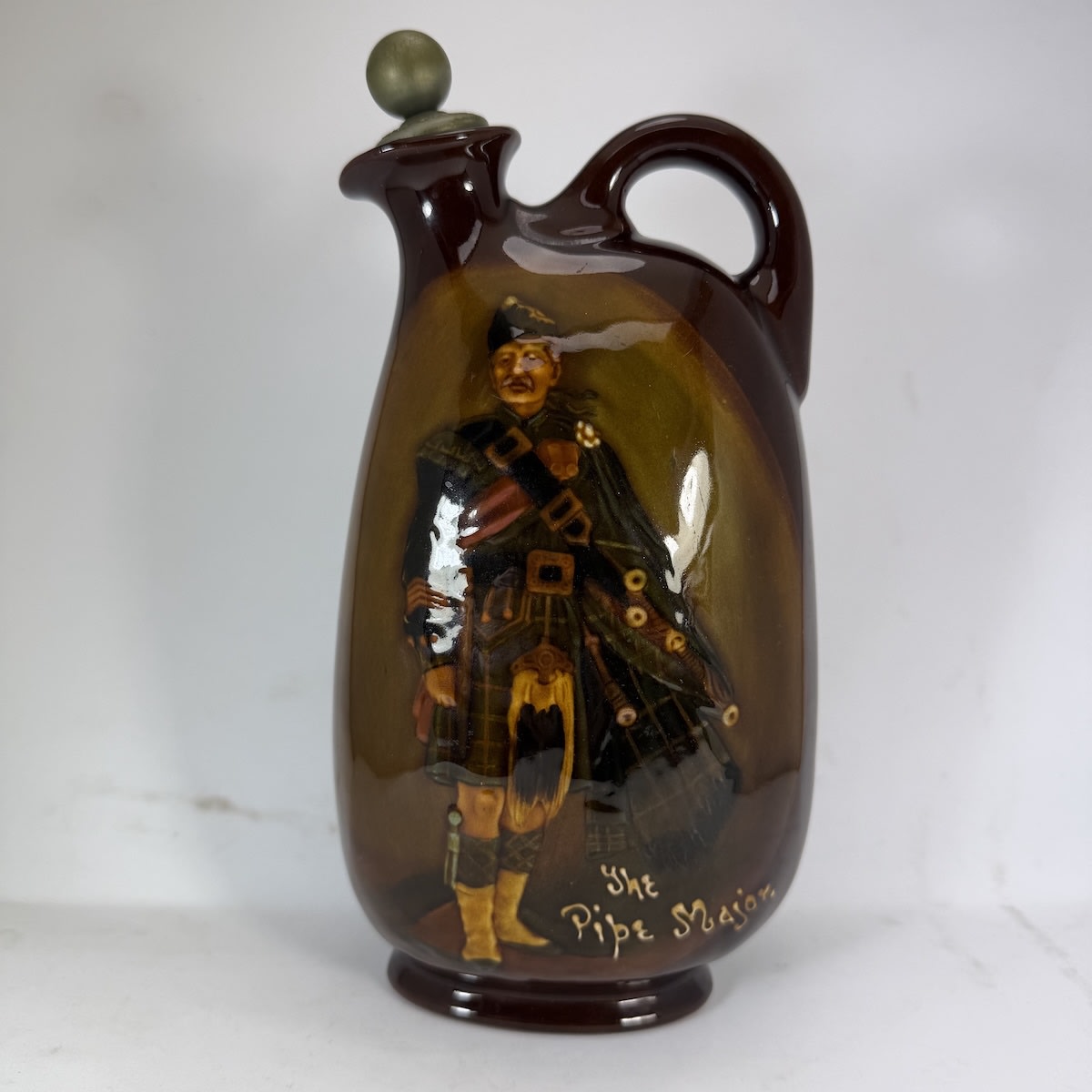 Kingsware Flagon. The Pipe Major. Dewar's Whisky. Royal Doulton. Dewar's metal top and cork.