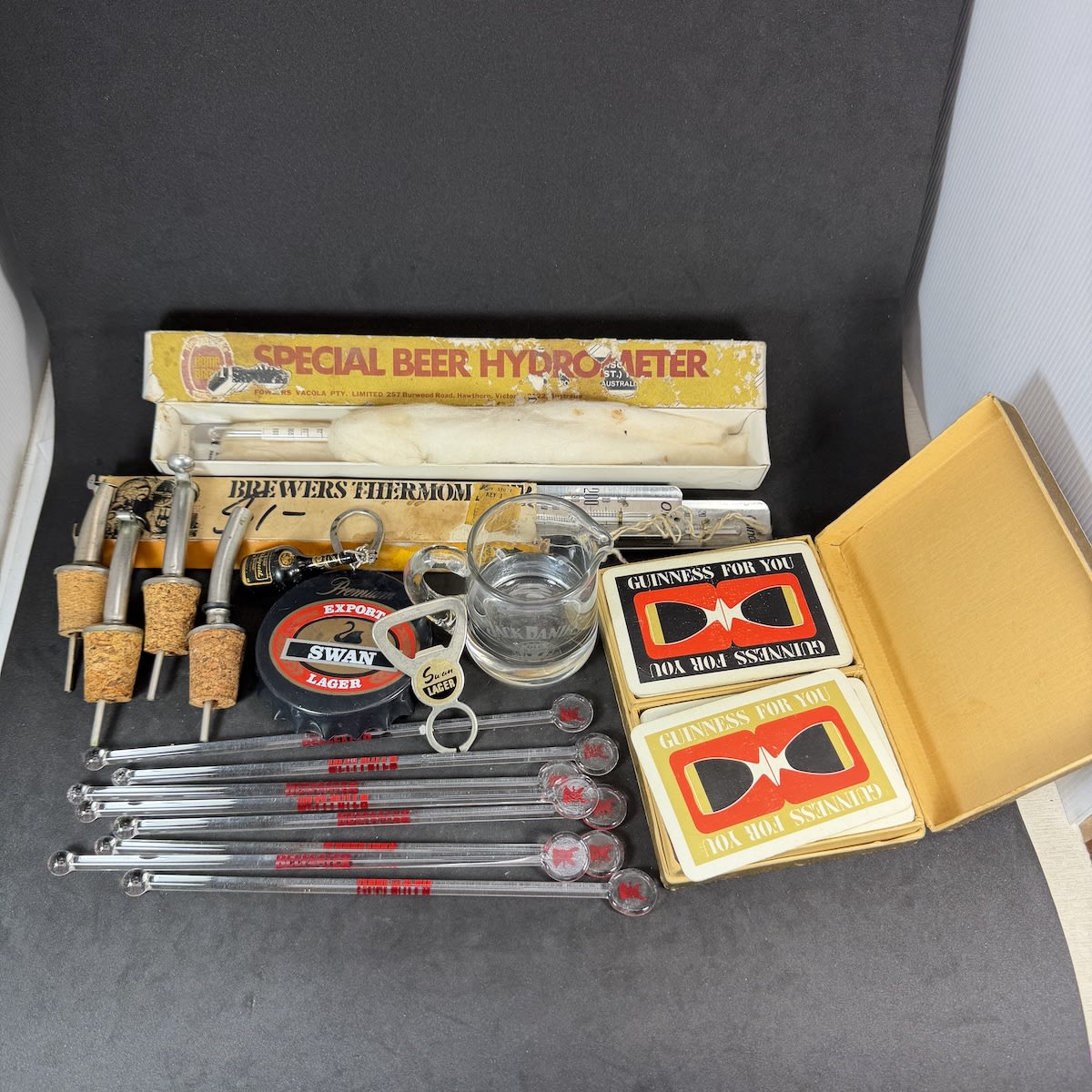 Big group Beer & Alcohol related items: Guinness playing cards 2 pack; Fowlers Vacola Beer Hydrometer; 8 Beefeater Gin swizzle sticks; Brewers Thermometer; 4 pourers; Tiny Jack Daniels measuring jug; 2 different Swan Lager Openers; Bisquit Keyring.