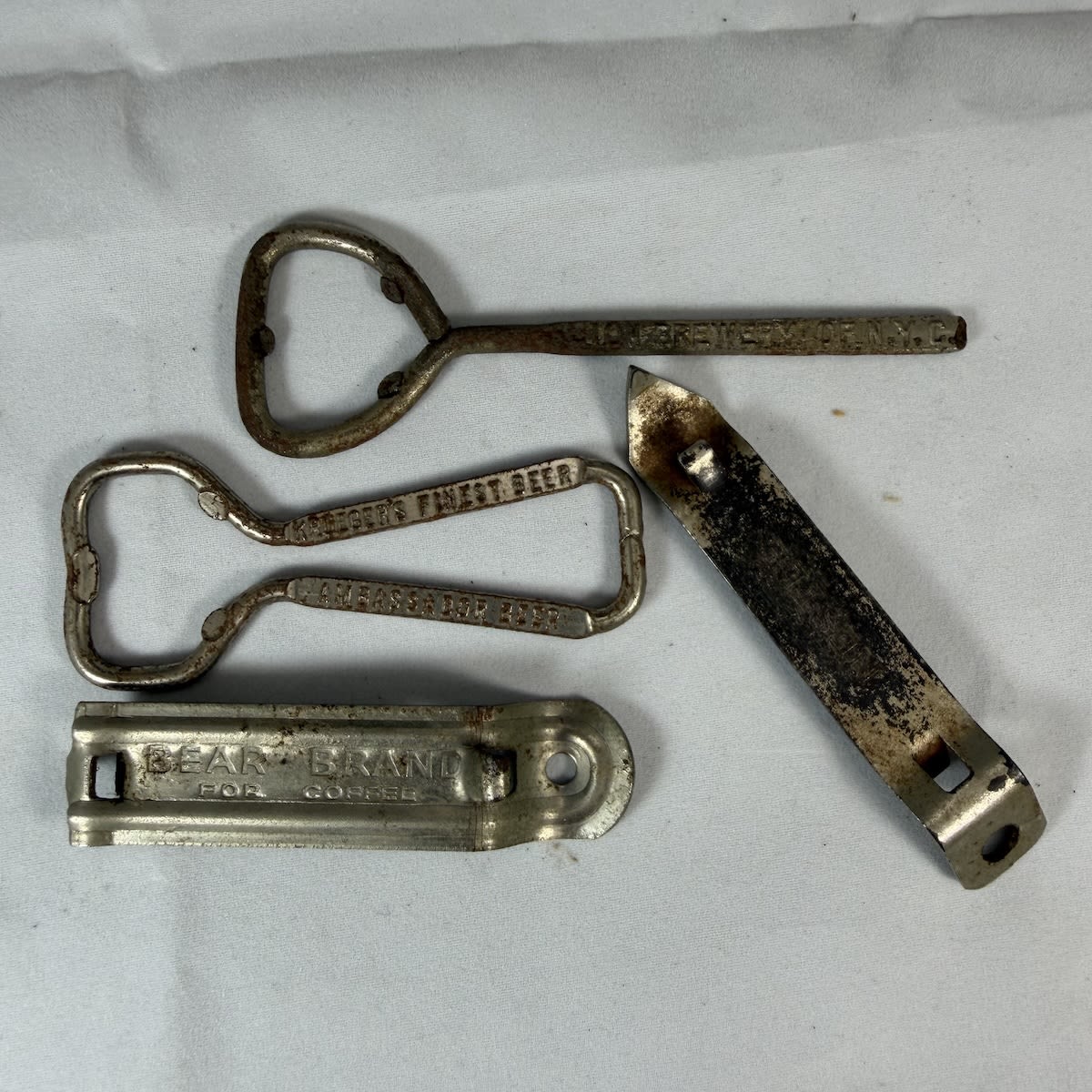4 Can & Bottle Openers: Lion Brewery of NYC; Krueger Brewing Co New Jersey; Nestle; Bear Brand for Coffee.