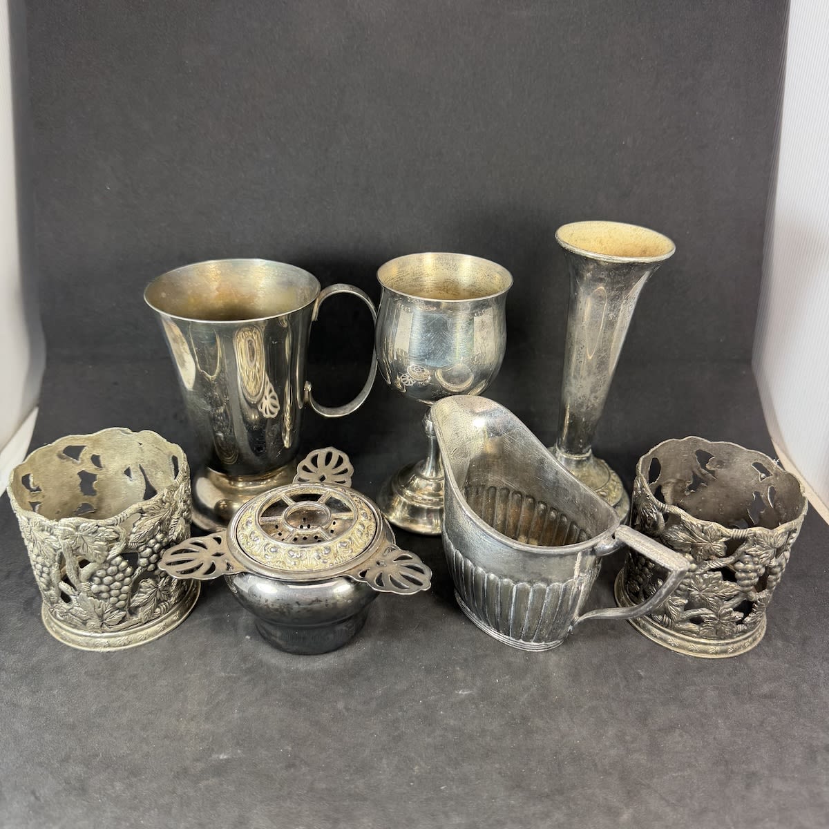 7 Medium pieces of plated metal. Goblet, Vases, Mug, Jug, etc.