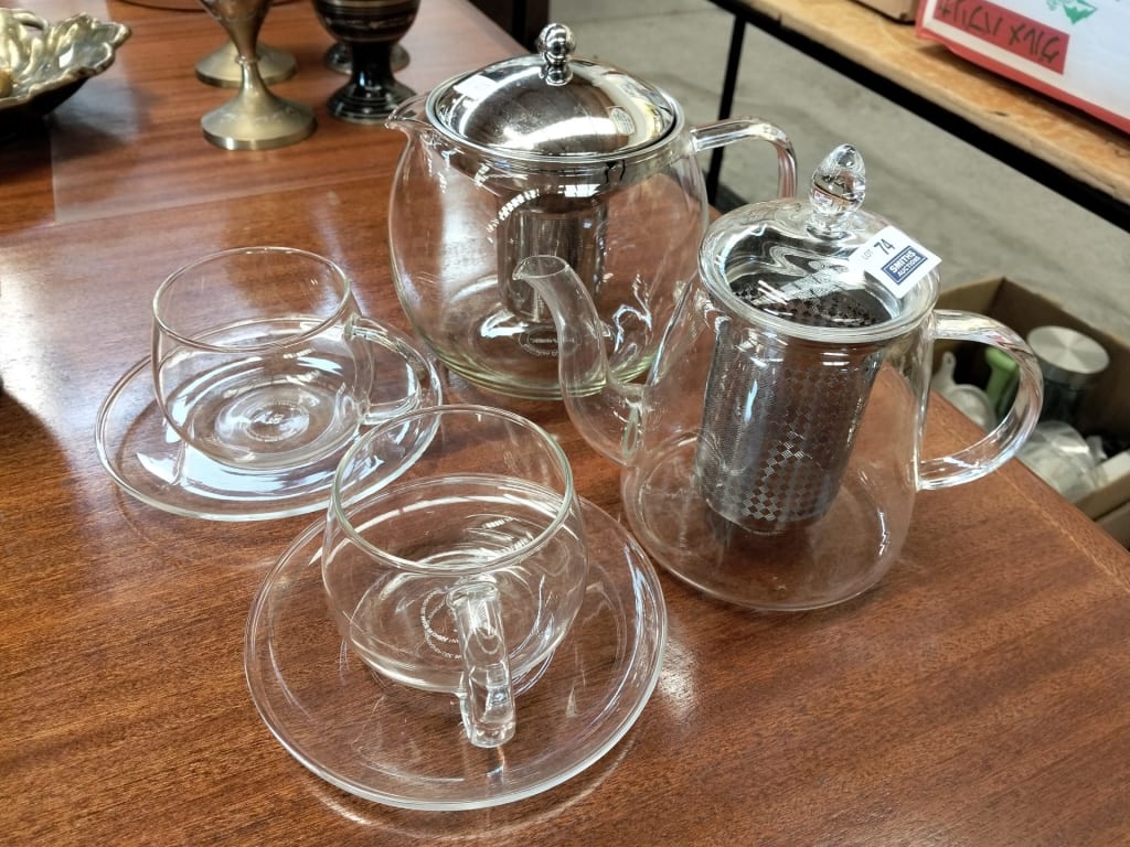 2 GLASS TEA POTS AND PAIR OF GLASS MUGS AND SAUCERS — NZ auction result